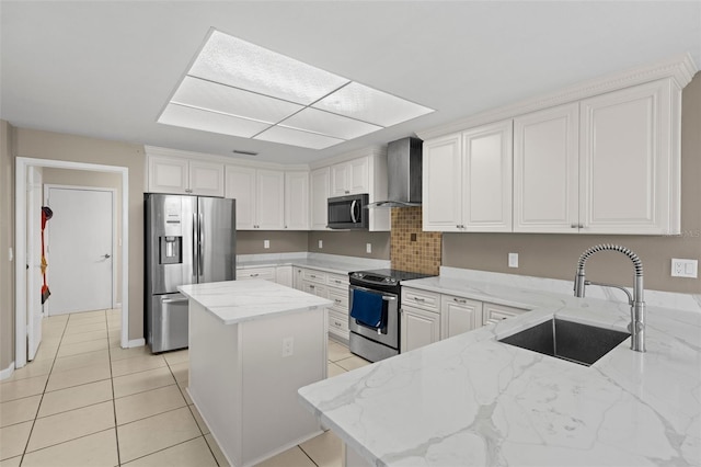 kitchen featuring light tile patterned floors, light stone countertops, a sink, appliances with stainless steel finishes, and wall chimney range hood
