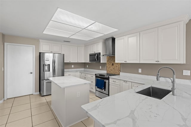 kitchen featuring light tile patterned floors, light stone countertops, a sink, appliances with stainless steel finishes, and wall chimney exhaust hood