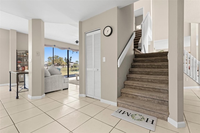 stairs featuring tile patterned flooring and baseboards