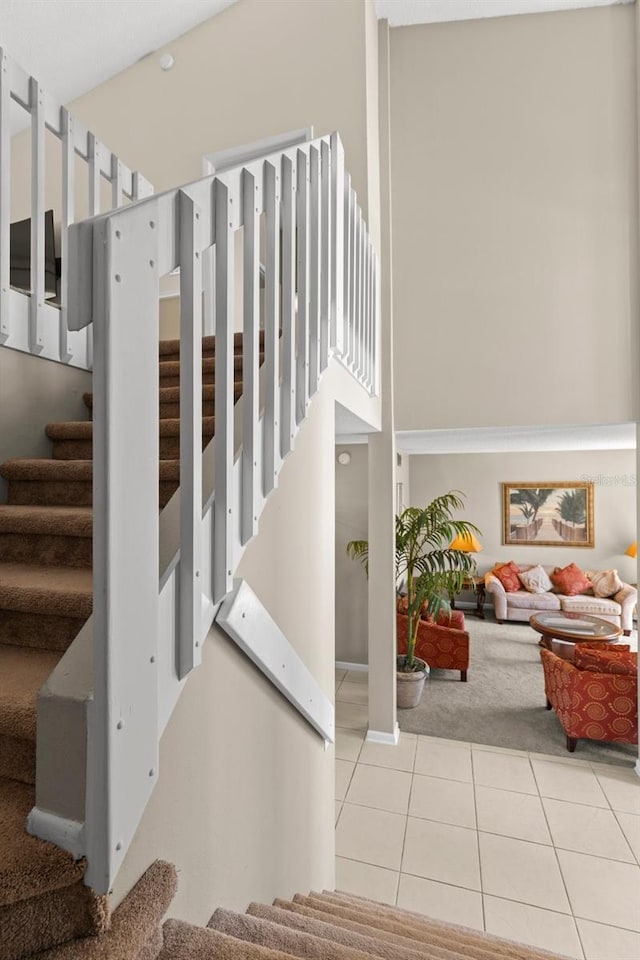 staircase featuring tile patterned flooring