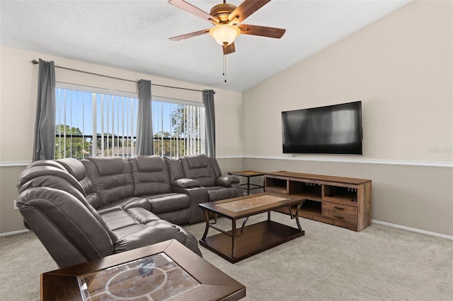 living room featuring carpet flooring, baseboards, ceiling fan, and vaulted ceiling