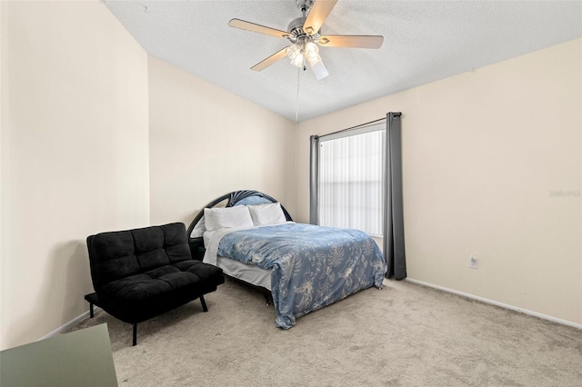 carpeted bedroom featuring baseboards, lofted ceiling, a textured ceiling, and ceiling fan
