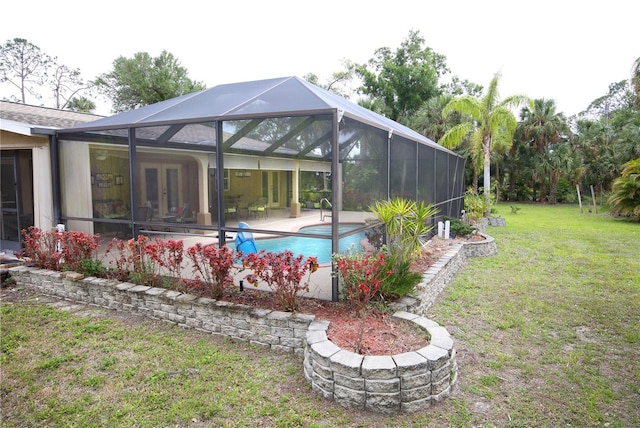 exterior space with a patio, an outdoor pool, french doors, a lanai, and a yard