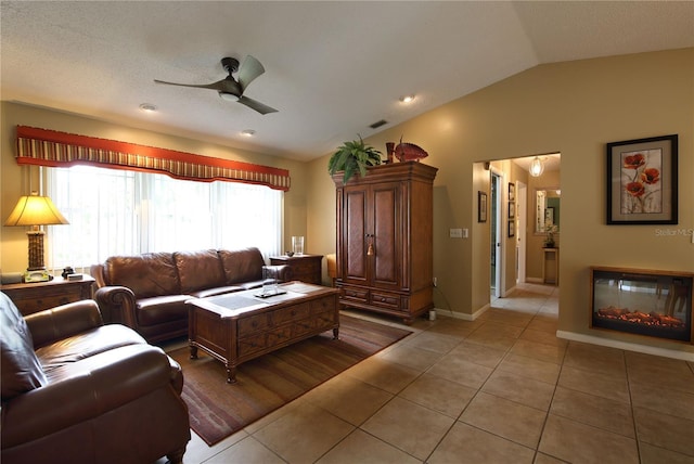 living room featuring lofted ceiling, visible vents, light tile patterned flooring, and ceiling fan