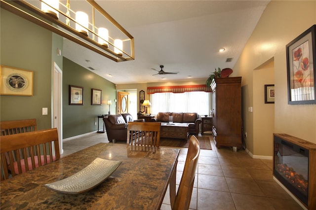 dining space with visible vents, baseboards, ceiling fan, tile patterned flooring, and lofted ceiling