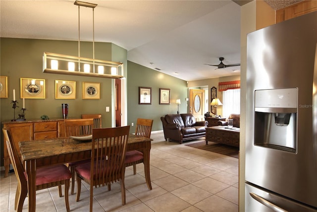 dining room with light tile patterned floors, a ceiling fan, and lofted ceiling