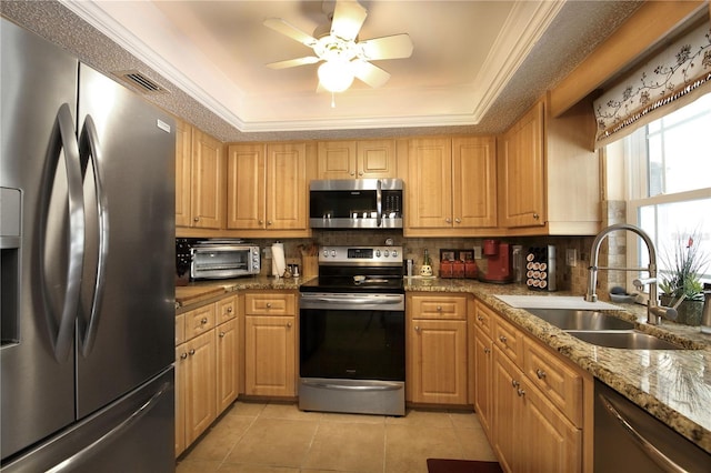 kitchen with stainless steel appliances, light tile patterned floors, a sink, and ornamental molding