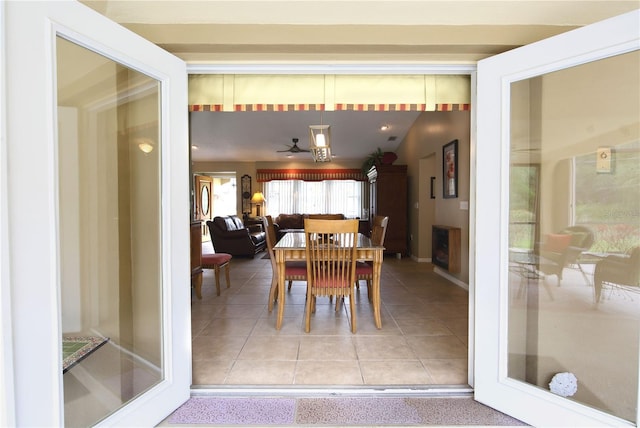 dining room with a ceiling fan and tile patterned flooring