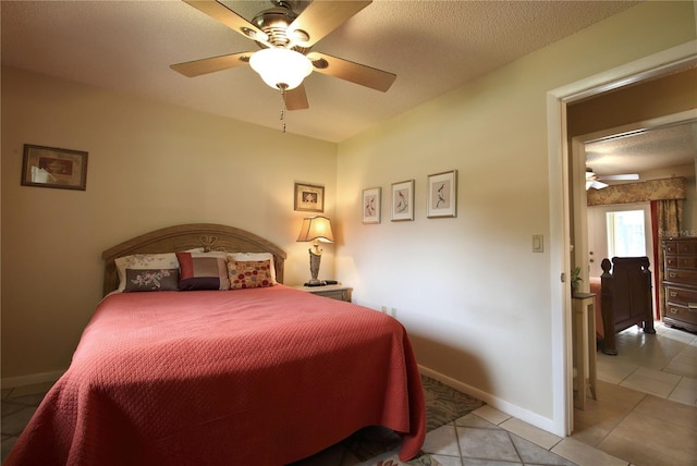 bedroom with light tile patterned floors, baseboards, a textured ceiling, and ceiling fan