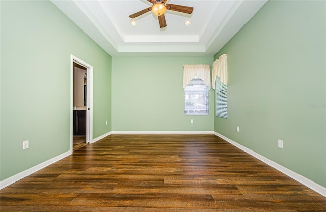 15925 Pond Rush Ct, Land O Lakes, FL 34638 - unfurnished room with ceiling fan, a raised ceiling, recessed lighting, and dark wood-style floors