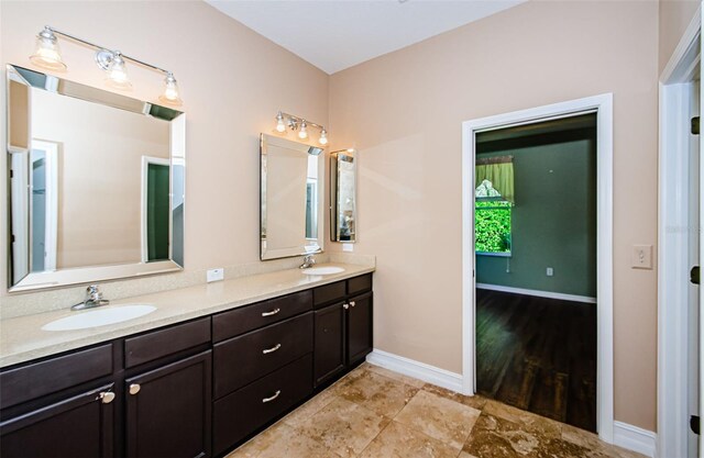 15925 Pond Rush Ct, Land O Lakes, FL 34638 - full bathroom with double vanity and baseboards