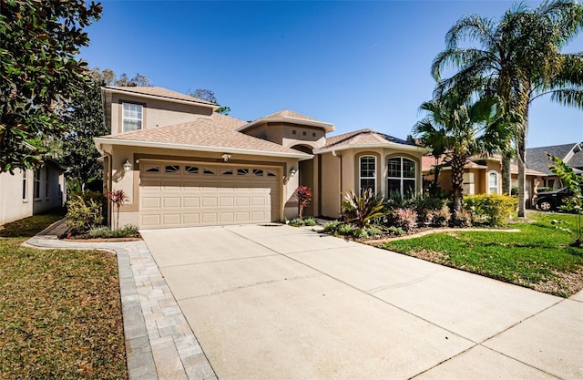 15925 Pond Rush Ct, Land O Lakes, FL 34638 - mediterranean / spanish-style house featuring stucco siding, a garage, and driveway