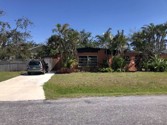 1465 Fundy Rd, Venice, FL 34293 - view of front of home with driveway, a front lawn, and fence