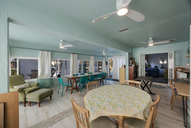 dining room with ceiling fan and visible vents