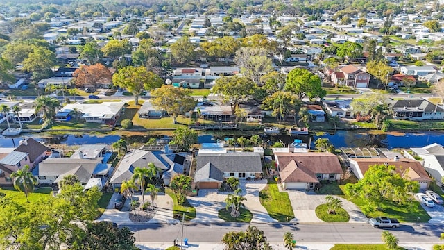 birds eye view of property with a water view and a residential view