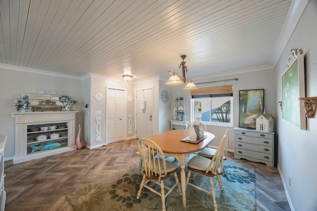 dining room with wooden ceiling, baseboards, and ornamental molding