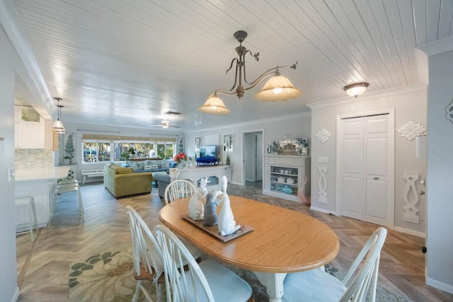dining area with crown molding, baseboards, and wooden ceiling