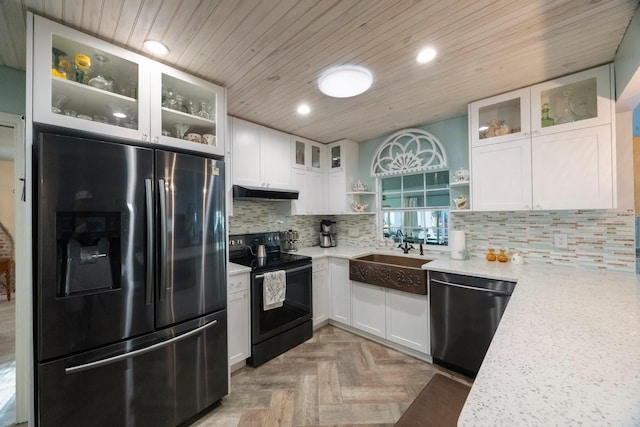 kitchen with a sink, dishwasher, black electric range, under cabinet range hood, and stainless steel refrigerator with ice dispenser