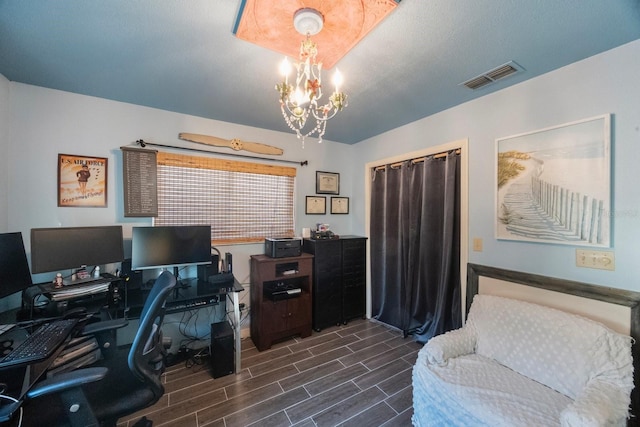 office space featuring a notable chandelier, visible vents, and dark wood-style floors