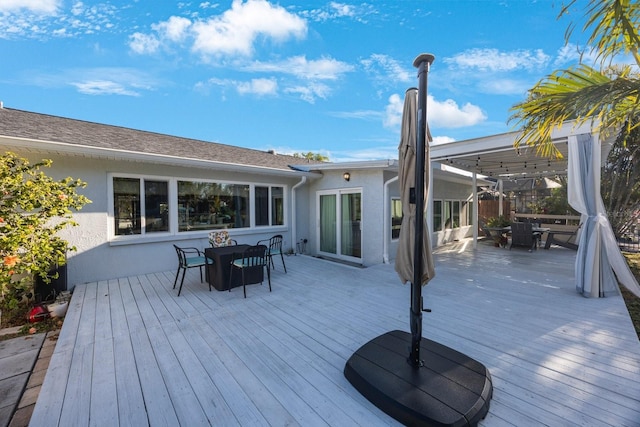 wooden deck featuring outdoor dining space