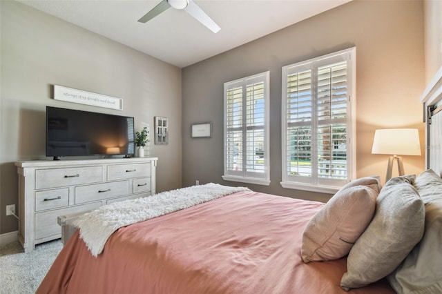 carpeted bedroom featuring a ceiling fan and baseboards