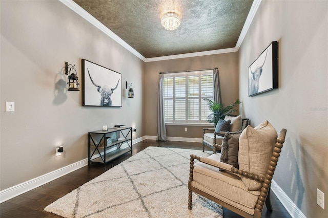living area with dark wood-style floors, baseboards, ornamental molding, a textured ceiling, and a chandelier