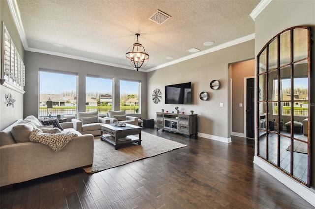 living area featuring visible vents, crown molding, baseboards, a notable chandelier, and wood-type flooring