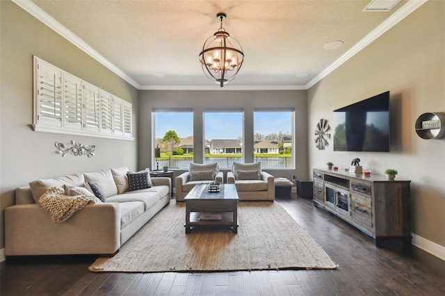 living area with an inviting chandelier, dark wood-type flooring, baseboards, and ornamental molding