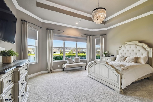 bedroom featuring light carpet, an inviting chandelier, crown molding, and a tray ceiling