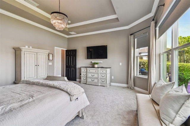 bedroom with a tray ceiling, multiple windows, a notable chandelier, and light colored carpet