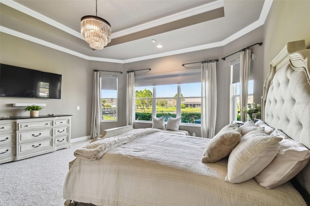 bedroom featuring a notable chandelier, carpet flooring, a raised ceiling, and ornamental molding