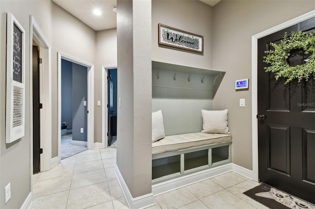 mudroom with tile patterned floors and baseboards
