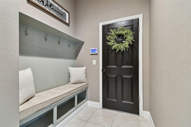 mudroom featuring light tile patterned floors and baseboards