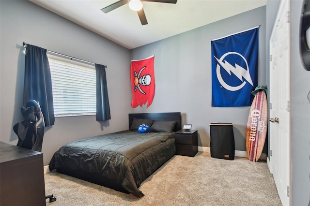 bedroom with a ceiling fan, baseboards, and carpet floors