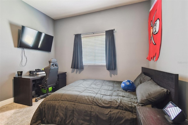 carpeted bedroom featuring baseboards