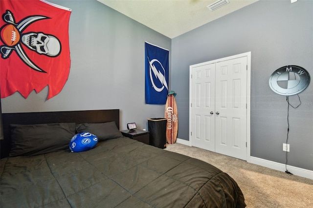 bedroom featuring a closet, baseboards, visible vents, and carpet floors