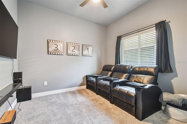 home theater room featuring baseboards, lofted ceiling, a ceiling fan, and carpet floors