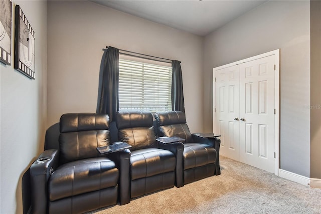 carpeted home theater with baseboards