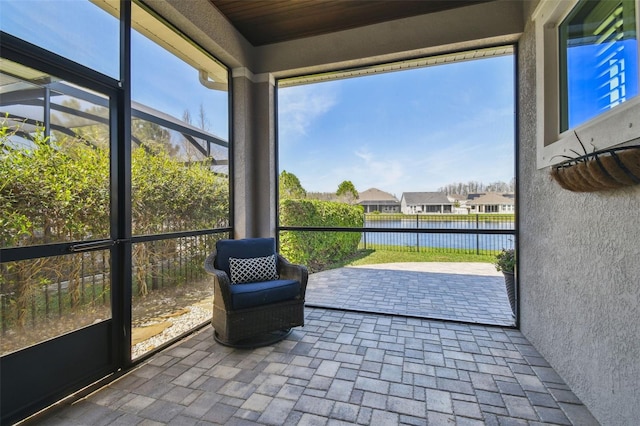 sunroom / solarium with a water view