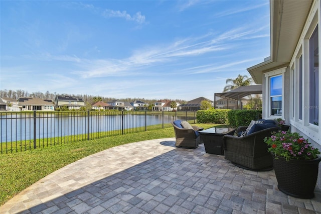 view of patio featuring a residential view, a fenced backyard, and a water view