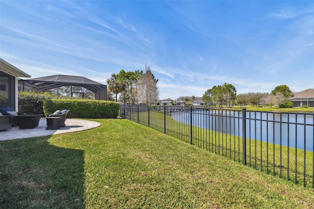 view of yard featuring a patio, a fenced backyard, and a water view