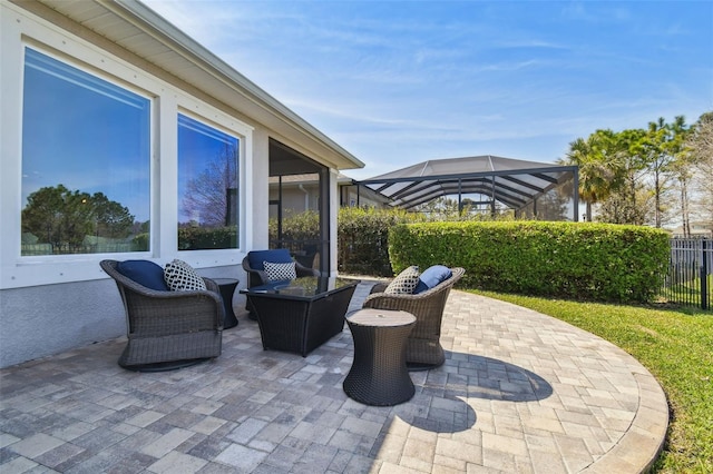 view of patio / terrace with glass enclosure and fence