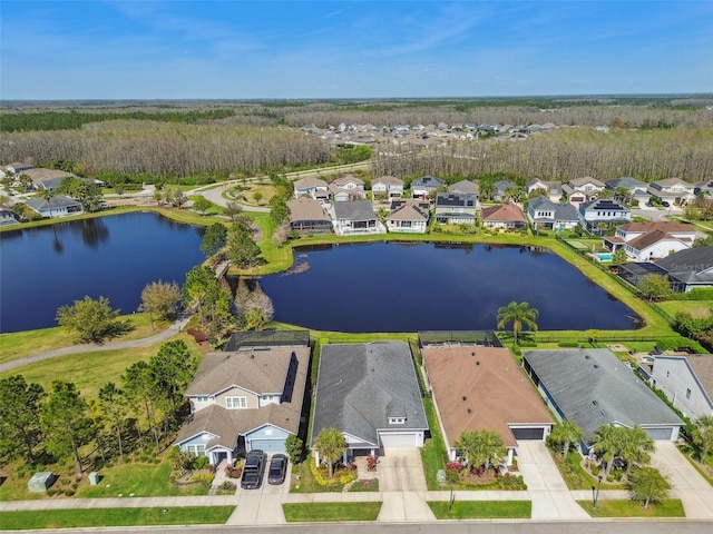 drone / aerial view with a residential view and a water view