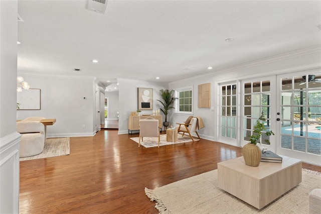 20315 Mid Ct, Lutz, FL 33558 - living room with crown molding, a healthy amount of sunlight, wood finished floors, and visible vents