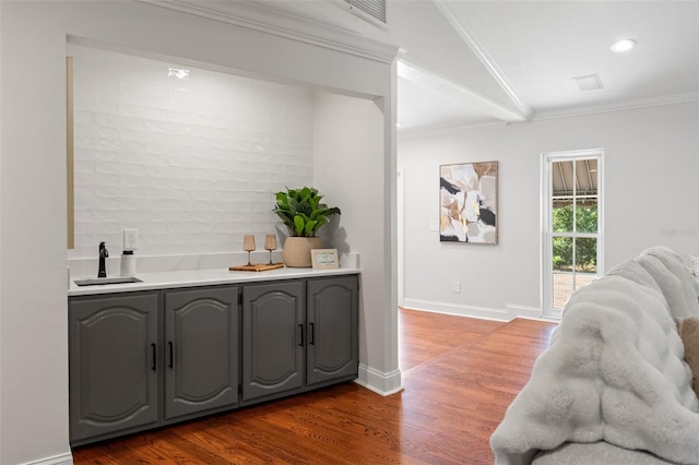 20315 Mid Ct, Lutz, FL 33558 - bar featuring a sink, ornamental molding, recessed lighting, and dark wood-type flooring