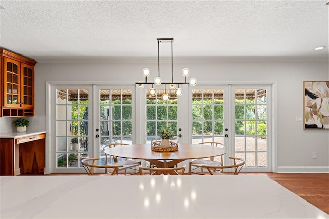 20315 Mid Ct, Lutz, FL 33558 - dining room with french doors, a textured ceiling, and wood finished floors