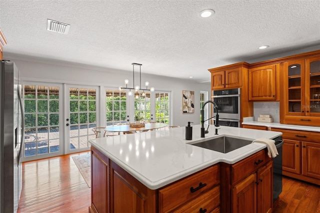 20315 Mid Ct, Lutz, FL 33558 - kitchen with french doors, visible vents, light countertops, a sink, and stainless steel appliances
