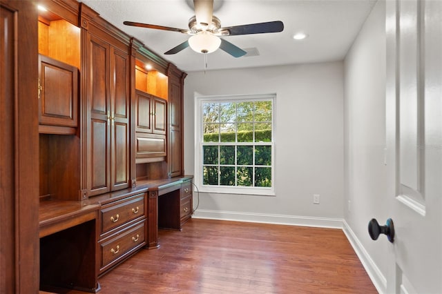 20315 Mid Ct, Lutz, FL 33558 - unfurnished office with a ceiling fan, built in desk, baseboards, recessed lighting, and dark wood-type flooring