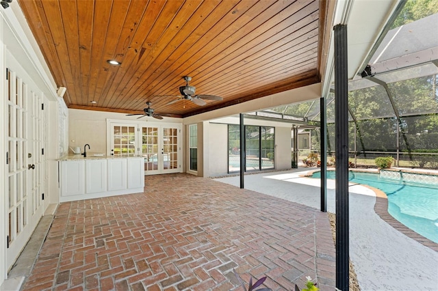 20315 Mid Ct, Lutz, FL 33558 - interior space with ceiling fan, a sink, an outdoor pool, french doors, and glass enclosure