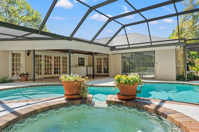 20315 Mid Ct, Lutz, FL 33558 - back of house featuring a ceiling fan, french doors, roof with shingles, a pool with connected hot tub, and stucco siding